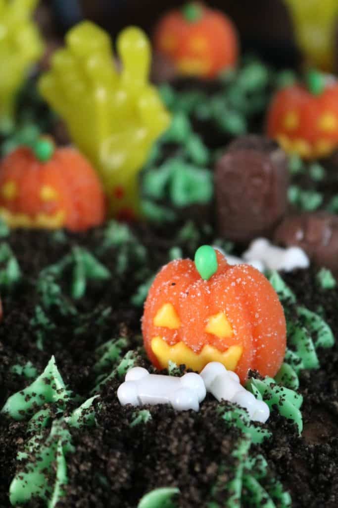 Gummy pumpkins and candy bones on Graveyard Brownies.
