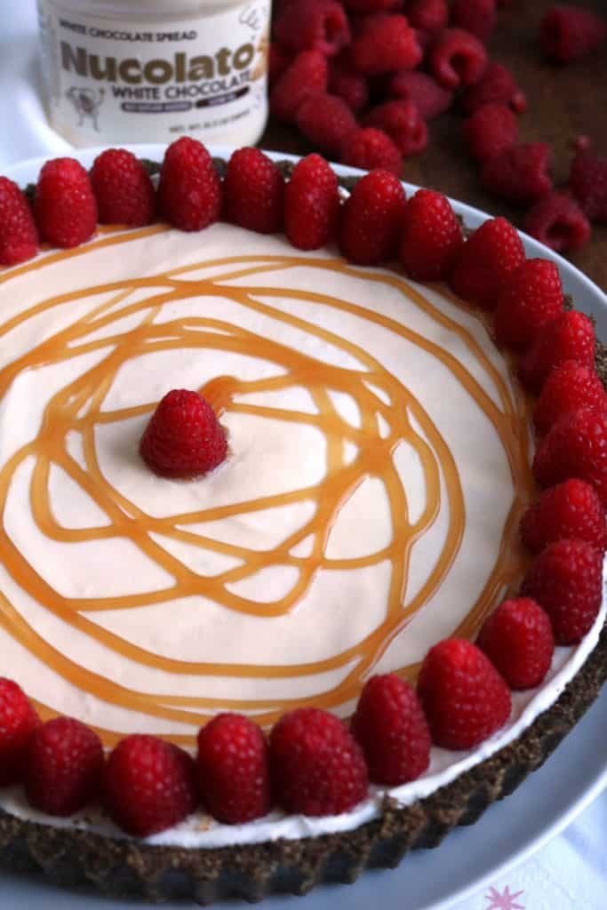 No Bake White Chocolate Pit topped with Caramel and Raspberries.