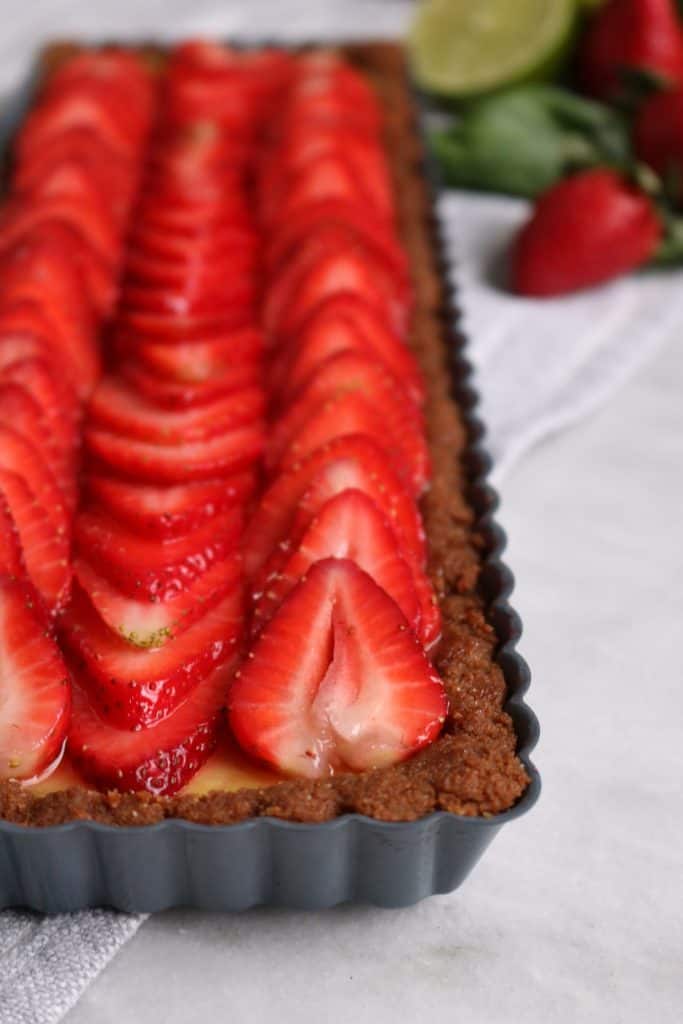 Strawberry Topped Basil Lime Curd Tart with Biscoff Crust.